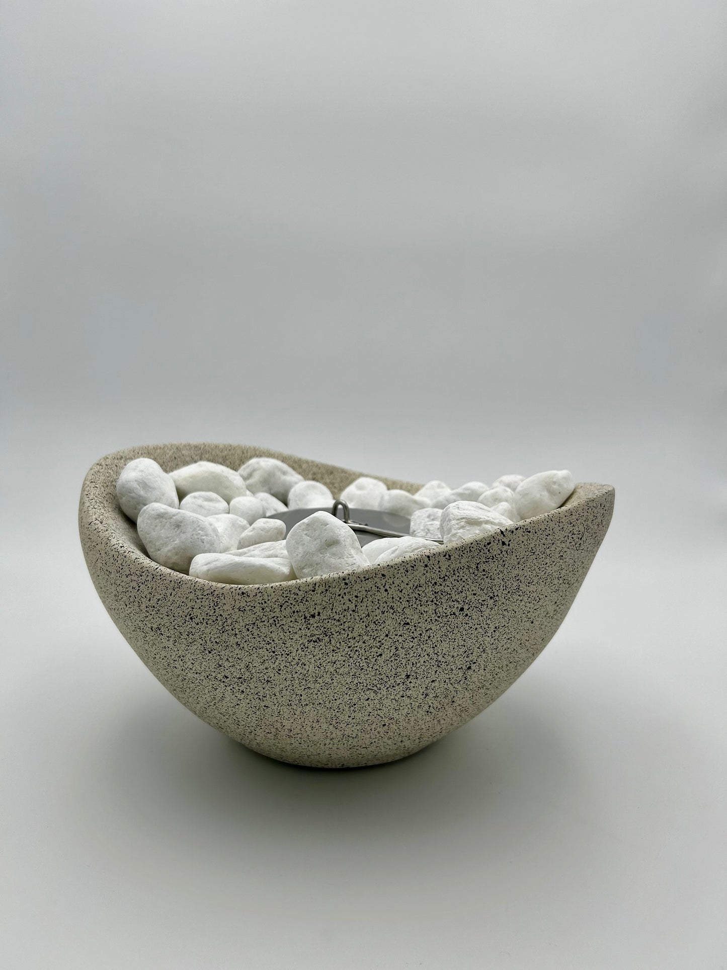 Beige Firepit with black stones