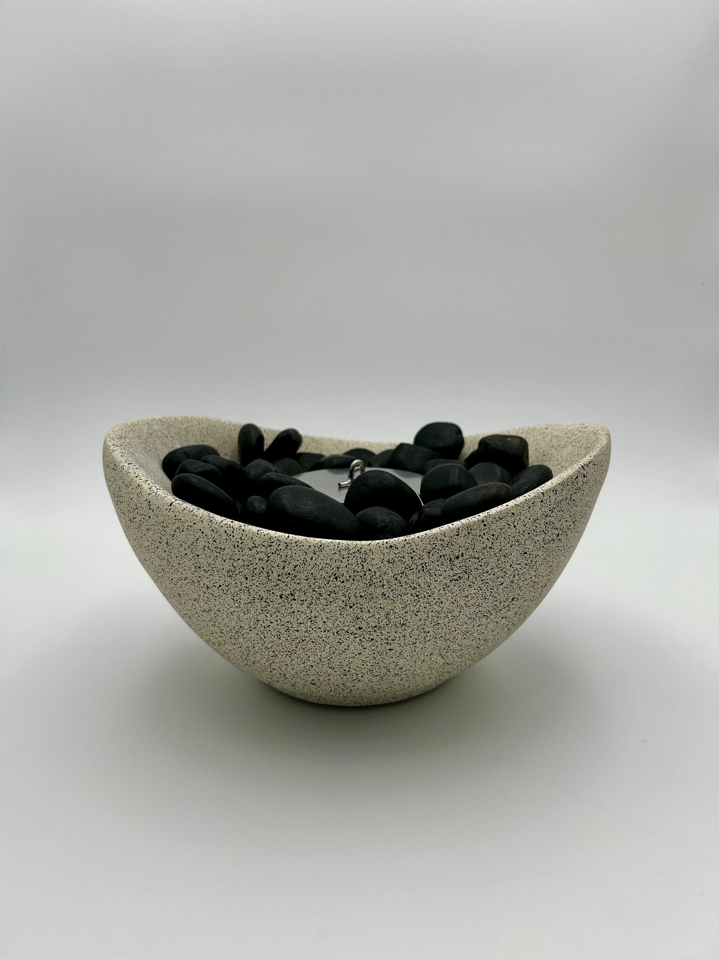 Beige Firepit with black stones