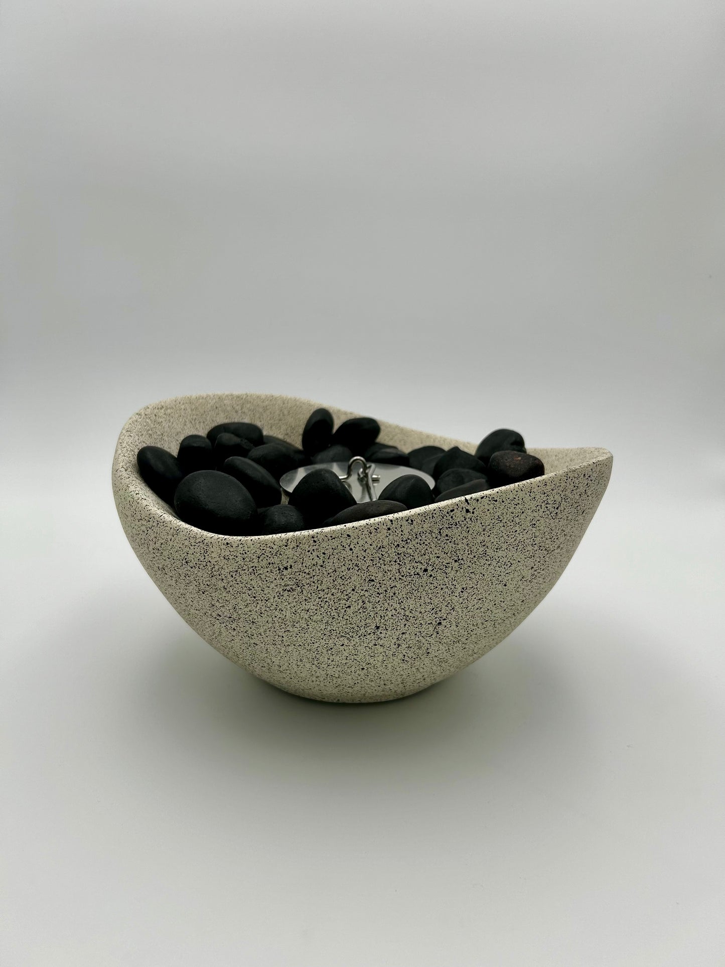 Beige Firepit with black stones